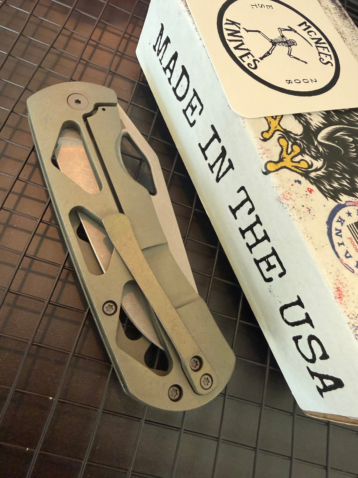 McNees Dixon 3.75 closed folding knife with skeletonized green titanium handle and matching titanium pocket clip