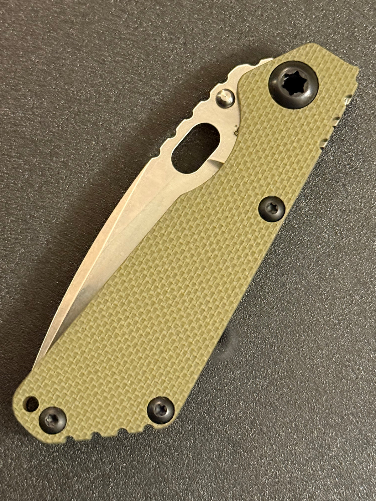 Strider Line folding knife showing blade thickness, spine jimping and G10 handle construction