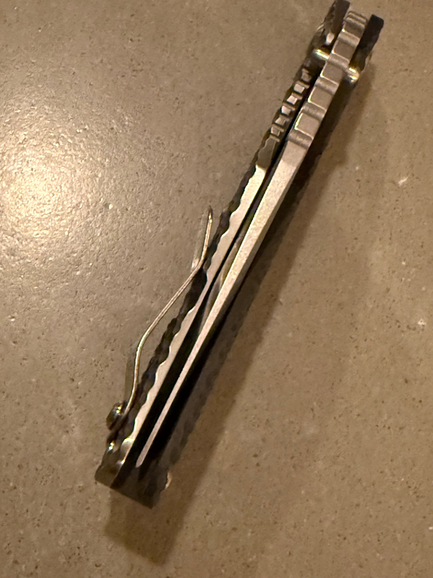 Strider SMF DGG hand-ground satin Bowie knife with textured titanium Gunner Grip lockside, titanium frame lock and upgraded hardware.