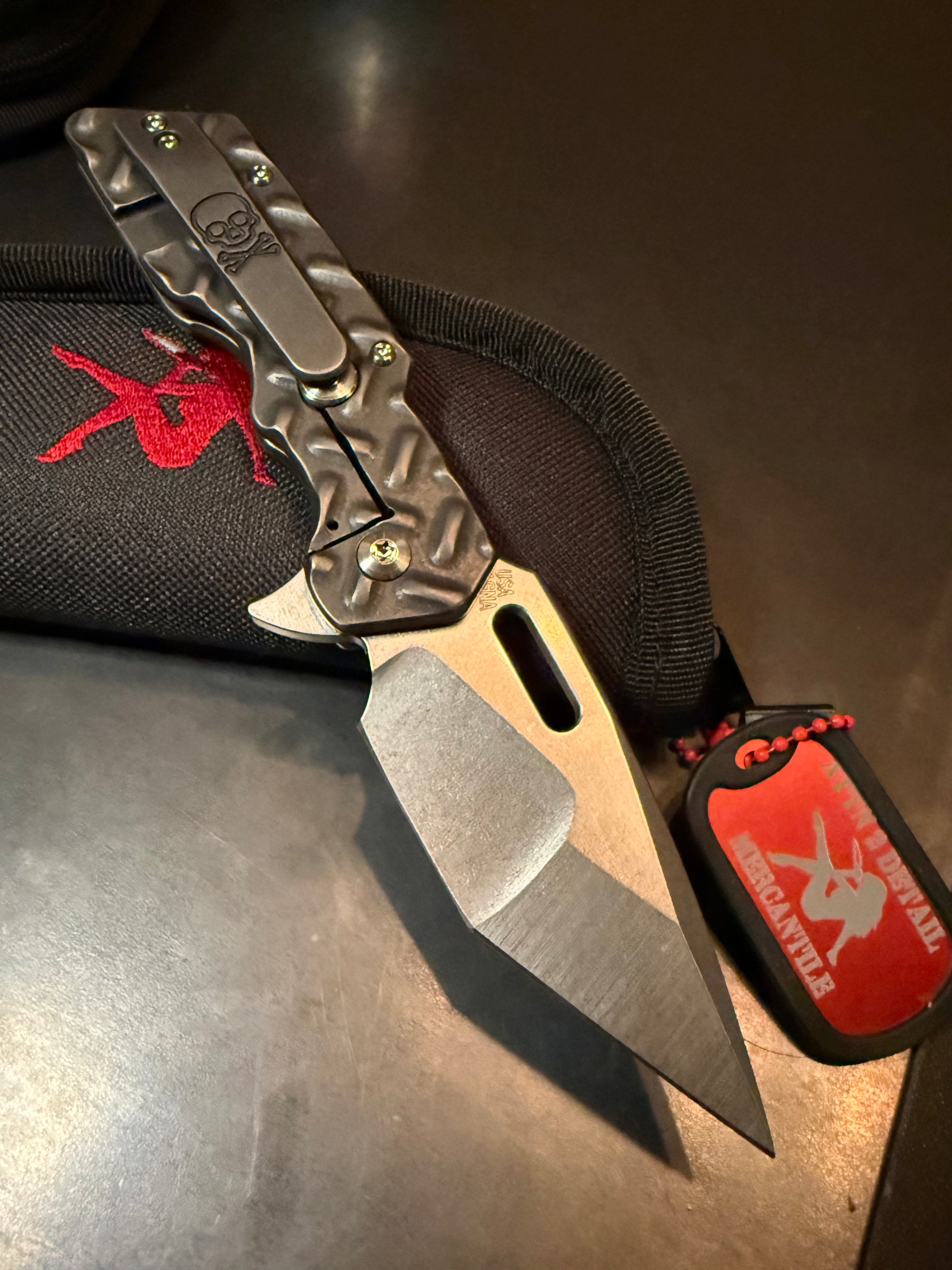 Attention 2 Detail Mercantile Mark 1 MED black washed titanium frame lock knife with Treadplate milling and skull pocket clip