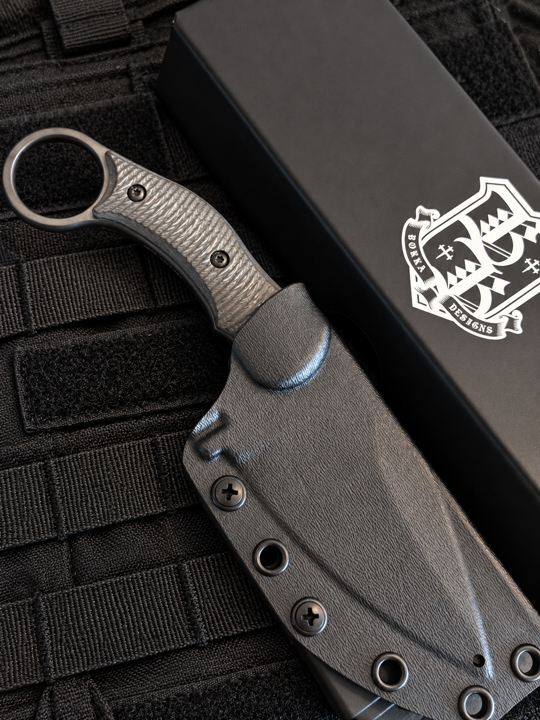 Close-up of Borka SRambit Böhler M390 drop point blade with black PVD finish, pronounced swedge and spine jimping.