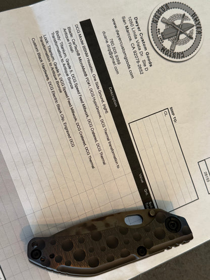 Closed Duane Dwyer BBN-M Hissatsu cratered Grade 5 titanium knife displayed with Dwyer Custom Goods specification paperwork.