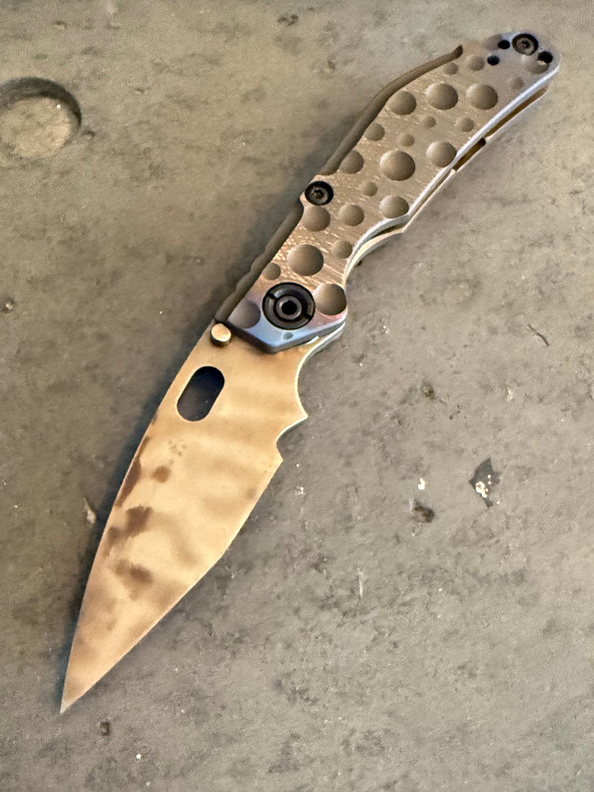 Duane Dwyer Custom Goods BBN-M Crater Hissatsu PD1 folding knife with Antique Bronze cratered titanium handle and thermal finished blade.