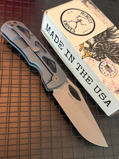 McNees Dixon 3.75 folding knife with stonewashed drop point blade and skeletonized blue titanium handle
