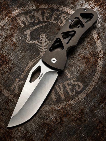 McNees Dixon 3.75 skeletonized bronze anodized titanium folding knife with satin stonewashed drop point blade