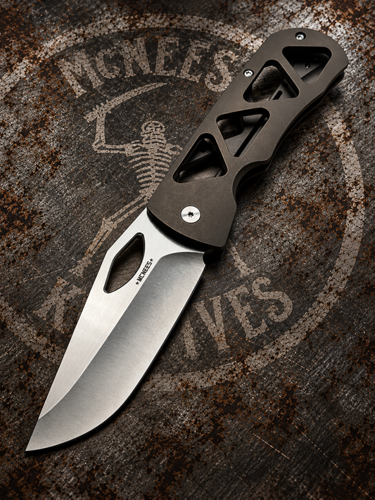 McNees Dixon 3.75 skeletonized bronze anodized titanium folding knife with satin stonewashed drop point blade