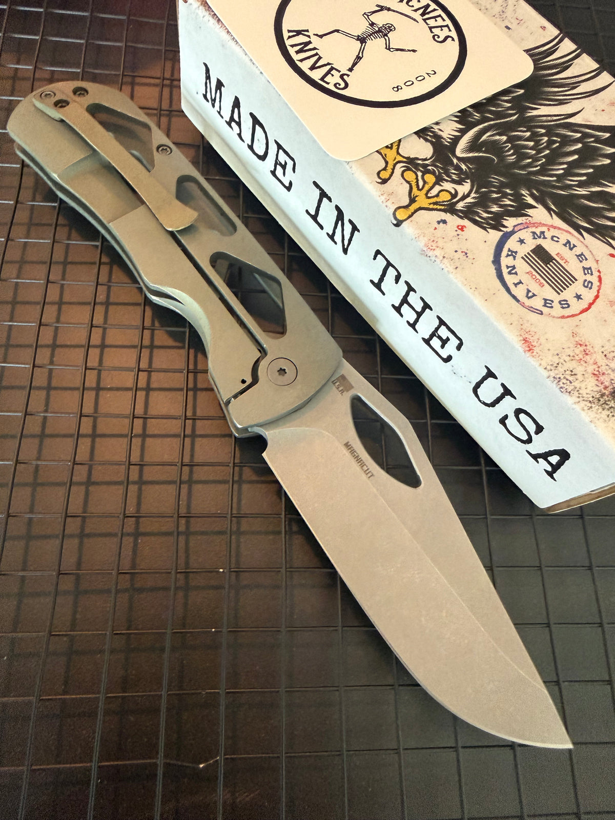 McNees Dixon 3.75 skeletonized green titanium frame lock knife showing stonewashed blade and matching pocket clip