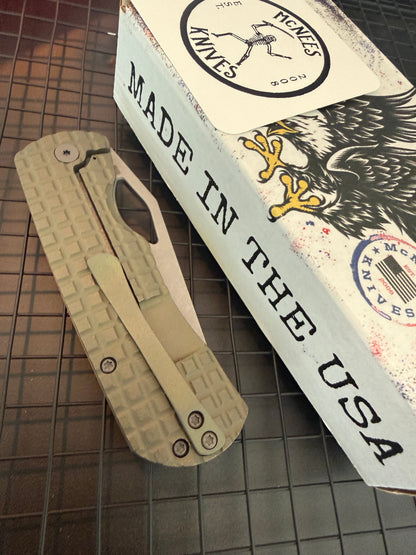 McNees Little Dixon 3.25 closed folding knife showing green FRAG milled titanium handle, bronze hardware and matching pocket clip
