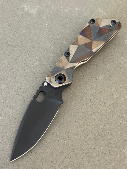 Mick Strider SnG Battleship Blade Show West limited edition with black MagnaCut spear point blade and full titanium camouflage handles