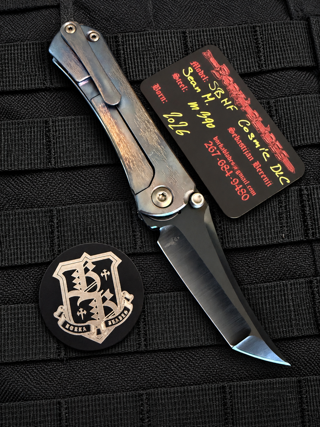 Open, frame-lock side
Borka Blades SBHF Cosmic DLC collaboration by Sebastijan Berenji and Sean Marfione showing hand-ground M390 black DLC blade and titanium frame lock.