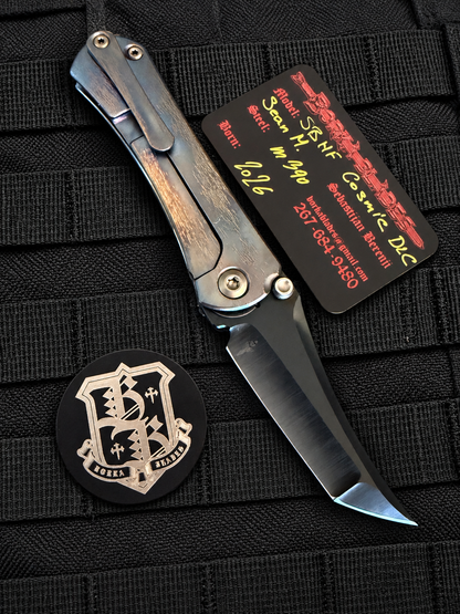Open, frame-lock side
Borka Blades SBHF Cosmic DLC collaboration by Sebastijan Berenji and Sean Marfione showing hand-ground M390 black DLC blade and titanium frame lock.