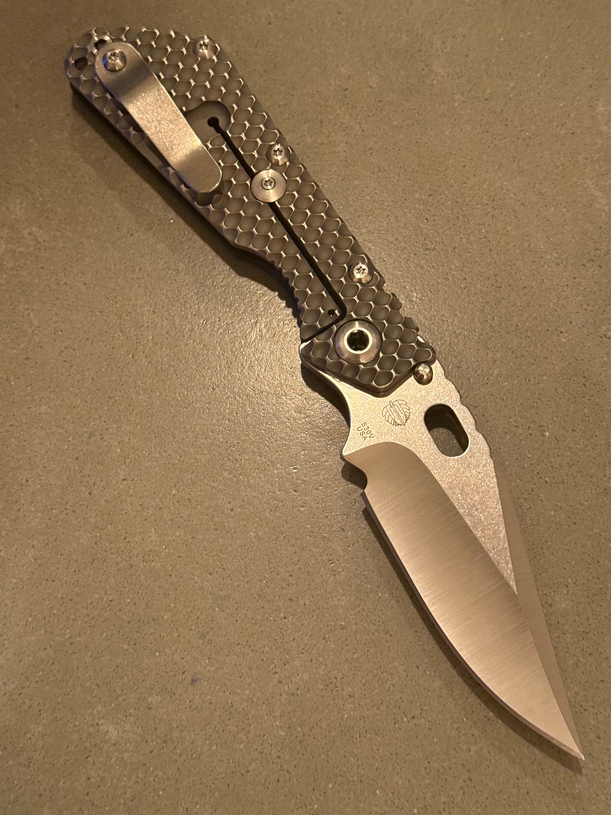 Strider SMF DGG spine view showing Double Gunner Grip G10 and titanium handle construction, pocket clip and jimping.