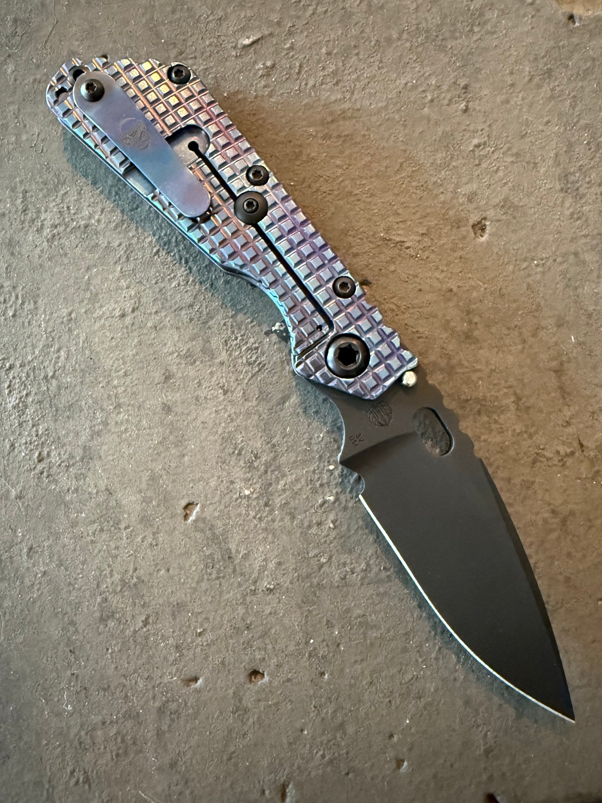 Strider SMF Monkey Edge FRAG titanium frame-lock side with blue purple heat anodizing, titanium pocket clip and CPM 3V spear point blade.